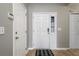 Bright entryway featuring neutral walls, tile flooring, a white front door with glass panes, and convenient coat closet at 240 Island Green Rd, Goose Creek, SC 29445