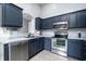 Modern kitchen with stainless steel appliances, dark cabinetry, and granite countertops at 240 Island Green Rd, Goose Creek, SC 29445