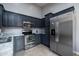 Modern kitchen with stainless steel appliances, dark cabinetry, and granite countertops at 240 Island Green Rd, Goose Creek, SC 29445
