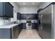 Modern kitchen with stainless steel appliances, dark cabinetry, and granite countertops at 240 Island Green Rd, Goose Creek, SC 29445