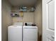 Bright laundry room with washer, dryer, and wire shelving for convenient storage at 240 Island Green Rd, Goose Creek, SC 29445