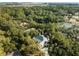 Beautiful aerial view of a house situated among trees, close to a pond, offering privacy and scenic beauty at 2455 The Haul Over, Seabrook Island, SC 29455
