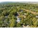 Wide aerial view of the property set within a lush, wooded community, showing the home's place among serene surroundings at 2455 The Haul Over, Seabrook Island, SC 29455