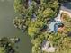High-angle view of a house near the water, featuring a green roof and enveloped by lush surroundings at 2455 The Haul Over, Seabrook Island, SC 29455