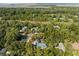 A scenic aerial view of a residence in a verdant neighborhood, featuring a mix of homes nestled within a leafy landscape at 2455 The Haul Over, Seabrook Island, SC 29455