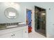 This bathroom features beautiful marble countertops, a round mirror, and a stunning glass door shower at 2455 The Haul Over, Seabrook Island, SC 29455