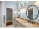 Luxurious bathroom with double vanity, granite countertop, and stylish lighting fixtures at 2455 The Haul Over, Seabrook Island, SC 29455