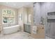 Luxurious bathroom with soaking tub, glass shower, and modern fixtures at 2455 The Haul Over, Seabrook Island, SC 29455