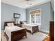 Cozy bedroom with two twin beds, soft lighting, and a large window with scenic views at 2455 The Haul Over, Seabrook Island, SC 29455