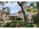 Inviting home exterior with lush tropical landscaping and mature trees surrounding the property at 2455 The Haul Over, Seabrook Island, SC 29455