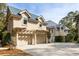 Beautiful home exterior with a three-car garage and well-maintained landscaping at 2455 The Haul Over, Seabrook Island, SC 29455