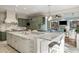 Open kitchen with a large marble island, modern appliances, and custom cabinetry at 2455 The Haul Over, Seabrook Island, SC 29455