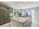 Spacious kitchen with large marble island, stainless fridge, and natural light at 2455 The Haul Over, Seabrook Island, SC 29455