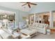 Cozy living room featuring light blue walls, a ceiling fan, and adjacent kitchen views at 2455 The Haul Over, Seabrook Island, SC 29455
