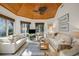 Bright living room with wood ceiling, neutral furnishings, and large windows at 2455 The Haul Over, Seabrook Island, SC 29455