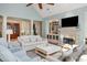 Open-concept living space with a fireplace, built-in shelving, and a door to the porch at 2455 The Haul Over, Seabrook Island, SC 29455