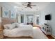 Bright main bedroom with views, a ceiling fan, and a seating area at 2455 The Haul Over, Seabrook Island, SC 29455