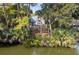 Picturesque waterfront home with a balcony, lush trees, and an in-ground pool at 2455 The Haul Over, Seabrook Island, SC 29455