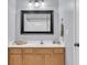 Well-lit bathroom features a vanity with decorative seashells, a large mirror, and modern fixtures at 250 Xavier St, Charleston, SC 29414