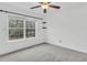 Bedroom features a ceiling fan, natural light from the window, and neutral carpet at 250 Xavier St, Charleston, SC 29414