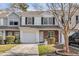 Charming townhome featuring a one-car garage and a well-maintained front yard with mature landscaping at 250 Xavier St, Charleston, SC 29414