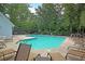 A serene community pool surrounded by lush greenery and comfortable lounge chairs at 250 Xavier St, Charleston, SC 29414