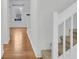 Carpeted staircase with white railing leads to the upper level, with a window at the top landing at 250 Xavier St, Charleston, SC 29414