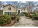 Charming home featuring mature trees and a welcoming entrance with an elegant staircase and manicured landscaping at 2595 Bohicket Rd, Johns Island, SC 29455