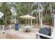 Inviting back deck features a table with umbrella, chairs, and serene wooded views at 2653 Seabrook Island Rd, Seabrook Island, SC 29455