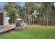 Expansive backyard with lush green grass, wooded views and elevated back deck at 2653 Seabrook Island Rd, Seabrook Island, SC 29455