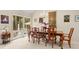 Bright dining room with hardwood table and chairs, accented by a chandelier and views of outdoor foliage at 2653 Seabrook Island Rd, Seabrook Island, SC 29455