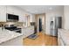 Kitchen with white cabinets, stainless appliances, granite counters, and a view to laundry room at 2653 Seabrook Island Rd, Seabrook Island, SC 29455