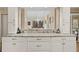 Granite countertop featuring white cabinets with silver hardware overlooking the dining room at 2653 Seabrook Island Rd, Seabrook Island, SC 29455