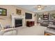 Spacious living room with fireplace, mounted TV, ceiling fan and comfortable seating at 2653 Seabrook Island Rd, Seabrook Island, SC 29455