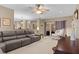 Open living room with a large sofa, fireplace, ceiling fan and access to the backyard at 2653 Seabrook Island Rd, Seabrook Island, SC 29455