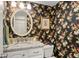Charming powder room with floral wallpaper, white vanity, and decorative mirror at 2653 Seabrook Island Rd, Seabrook Island, SC 29455