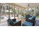 Bright sunroom with wicker furniture, ceiling fan, and serene outdoor views at 2653 Seabrook Island Rd, Seabrook Island, SC 29455