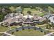 A detailed aerial view of the building showcasing its design and landscaping, with a golf course and lush trees in the background at 2653 Seabrook Island Rd, Seabrook Island, SC 29455