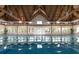 Indoor pool with vaulted ceilings, exposed wood beams and abundant natural light at 2653 Seabrook Island Rd, Seabrook Island, SC 29455