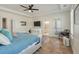 Bright main bedroom featuring a tray ceiling, hardwood floors, and an exterior door at 2751 Rutherford Way, Charleston, SC 29414