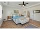 Bright main bedroom featuring a tray ceiling, hardwood floors, and a decorative bench at 2751 Rutherford Way, Charleston, SC 29414