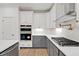 Gourmet kitchen with stainless steel appliances, white cabinets, and stylish backsplash at 2924 Lodge Berry Ln, Johns Island, SC 29455