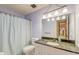 Bathroom with vanity, lighting fixture, toilet and shower with blue accents at 306 Runnymede Ln, Summerville, SC 29485