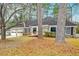 A charming brick home with a ramp entrance, garage, and mature trees in the front yard at 306 Runnymede Ln, Summerville, SC 29485
