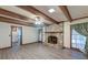 Bright living room with exposed wood beams and a brick fireplace at 306 Runnymede Ln, Summerville, SC 29485