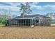 View of the spacious screened porch and brick exterior of this charming home at 306 Runnymede Ln, Summerville, SC 29485