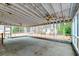 Large screened porch featuring ceiling fans and views of the surrounding landscape at 306 Runnymede Ln, Summerville, SC 29485