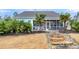 Lush backyard with palm trees, patio, stone steps with lights, and exterior view of screened porch at 3115 Cross Vine Ln, Summerville, SC 29483