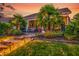 Beautiful backyard with palm trees, lush plants, patio and stone steps with landscape lighting at 3115 Cross Vine Ln, Summerville, SC 29483
