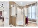 Bright bathroom with a glass-enclosed shower and a large window, adjacent to the bedroom at 3115 Cross Vine Ln, Summerville, SC 29483